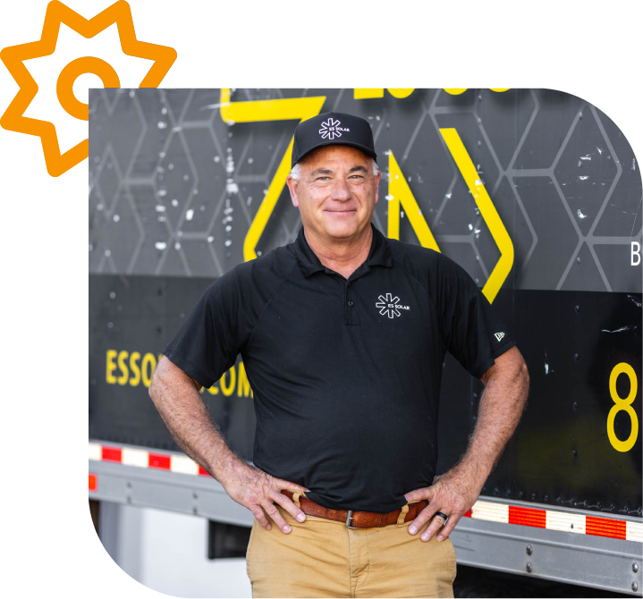 Man in black polo and cap smiling.
