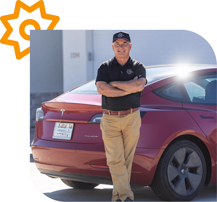 Man standing beside a red Tesla car.